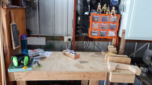 Image of a bench space used for woodworking, including tools and PPE.